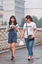 Skinny and fat Chinese girls on a pedestrian bridge, Beijing, China
